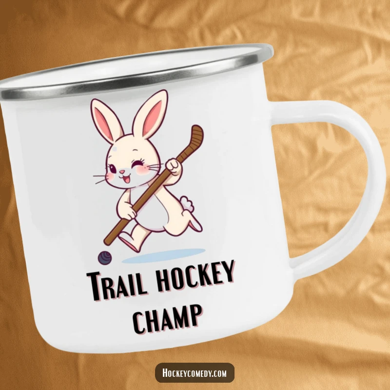 Funny camping mug showing a rabbit hopping with a hockey stick, perfect for outdoor sports fans and humor lovers.