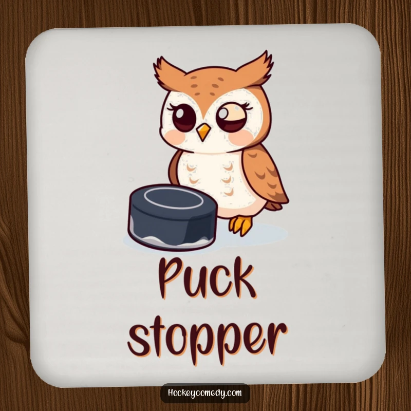 Funny owl attempting to catch a hockey puck on a drink coaster, offering humorous tabletop protection.