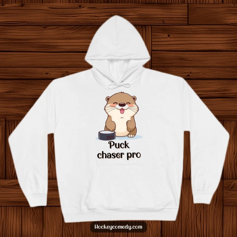 Funny cheerful otter trying to catch a hockey puck with its nose on a soft, humorous hoodie.