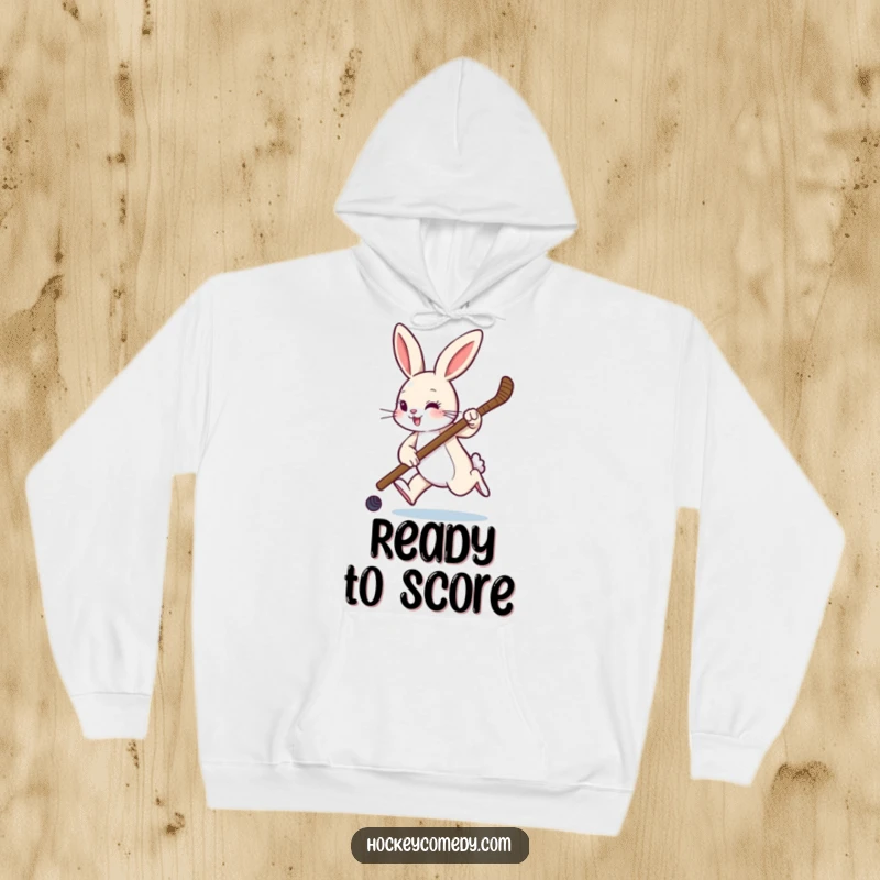 Funny hoodie with a playful rabbit hopping with a hockey stick, ideal for cozy warmth and showcasing sports passion.