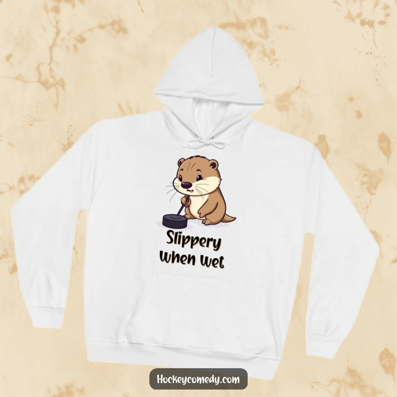 Funny Hoodie with a silly otter comically trying to dribble a hockey puck with its nose, perfect for staying warm and conveying playful humor.
