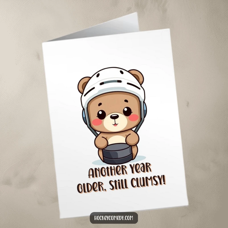 Funny Free Printable Birthday Card: A small bear in a helmet comically misses a hockey puck, creating a hilarious birthday wish.