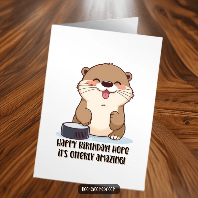 Funny Free Printable Birthday Card: A cheerful otter tries to catch a hockey puck with its nose, celebrating a special day.