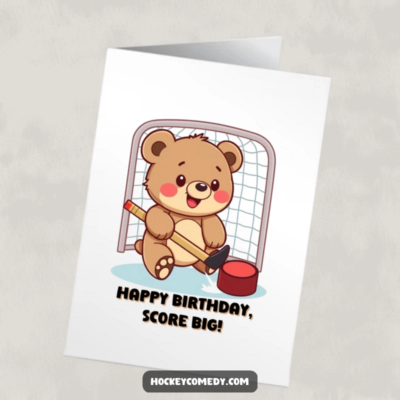 Funny Free Printable Birthday Card: Bear cub enthusiastically swatting a hockey puck into a net, pure playful joy.