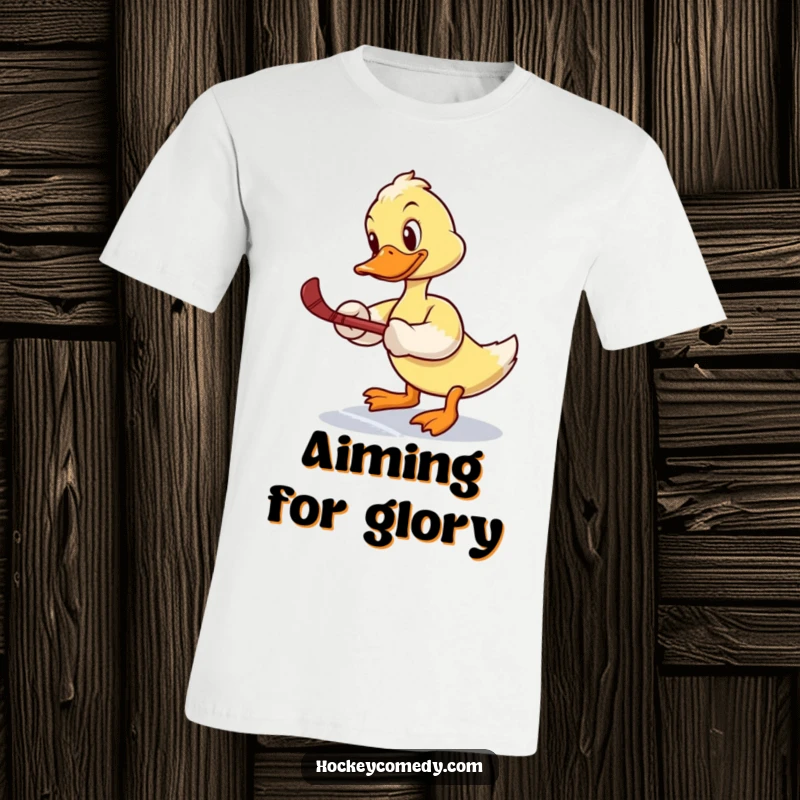 Funny t-shirt: A determined duck tries a slap shot, wobbling hilariously on the ice, making for a comical sports moment.