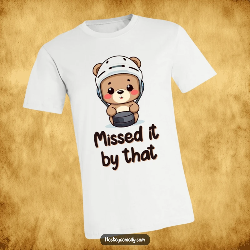 Funny bear wearing a hockey helmet comically misses a puck on this humorous sports t-shirt.